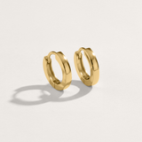 1cm rounded shape hypoallergenic huggie earrings in gold on white background
