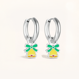 Silver hoop earrings with green and yellow bell charms on a light pink background