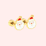 Gold Father Christmas Flat Back Style Earrings with a red hat on a light pink background.