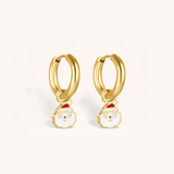 Gold hoop earrings with Santa face charms on a white background