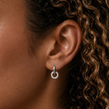 Close-up of model wearing Silver Infinity Double Hoop Earrings with an interlocking double hoop design and pavé-set cubic zirconia stones