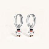 Silver hoop earrings with snowman charms on a light background.