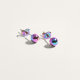 Ball hypoallergenic stud earrings in pearlescent finish on white background