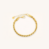 Gold braided bracelet on a white background.
