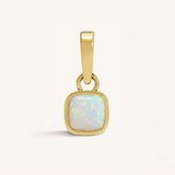 Gold pendant with an opal gemstone on a white background.