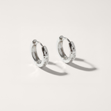 Silver hoop earrings on a light gray background