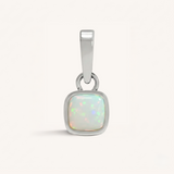 Silver pendant with an opal gemstone on a white background.