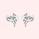 Pair of silver webbed earrings on a light pink background