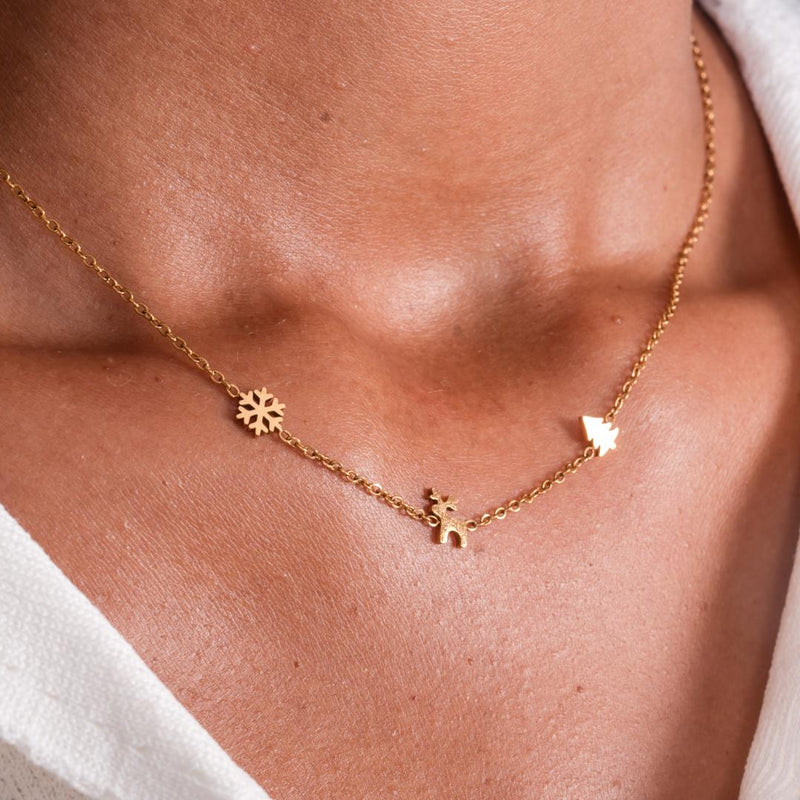 A girl wearing the Christmas Trio Necklace in gold.