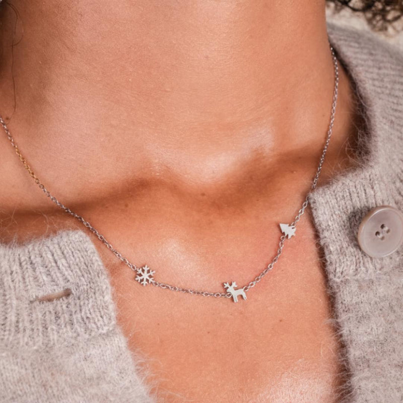 A girl wearing the Christmas Trio Necklace in silver.