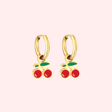 Gold cherry hoop earrings  on a light pink background