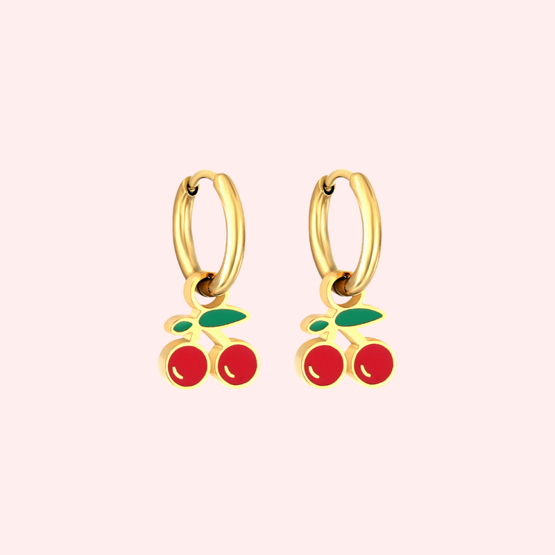 Gold cherry hoop earrings  on a light pink background