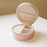 Pink, small round jewellery case with cream interior and multiple compartments