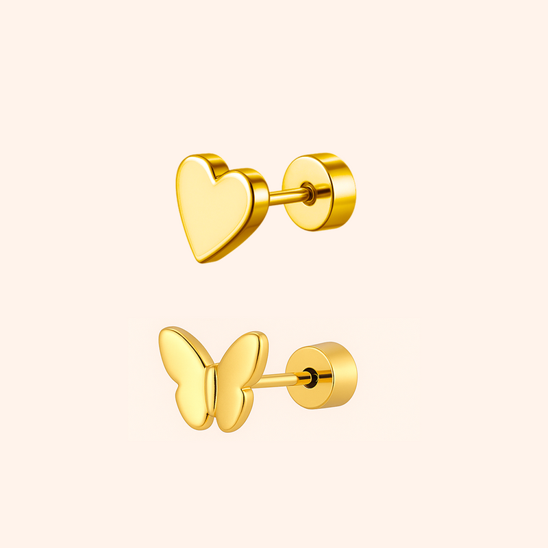 Gold heart and butterfly earrings on a light pink background