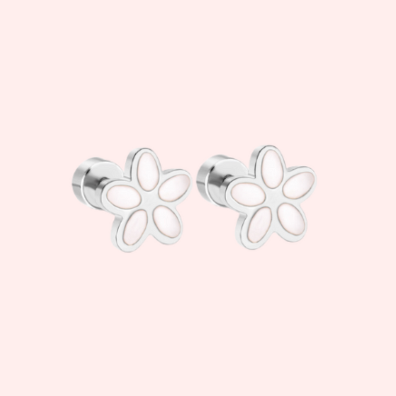 Silver flower-shaped earrings on a light pink background