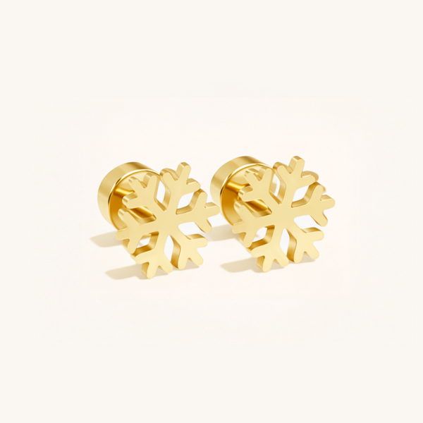 Gold snowflake-shaped earrings on a light pink background