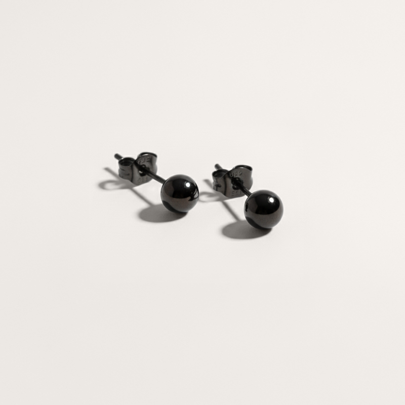 Ball hypoallergenic stud earrings in black on white background

