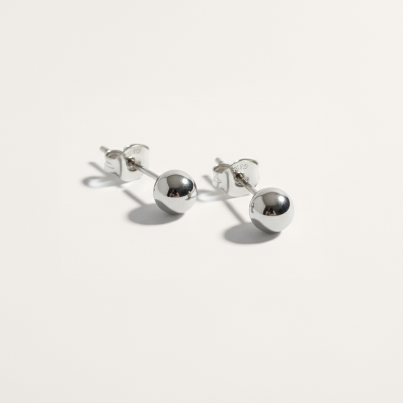 Ball hypoallergenic stud earrings in silver on white background
