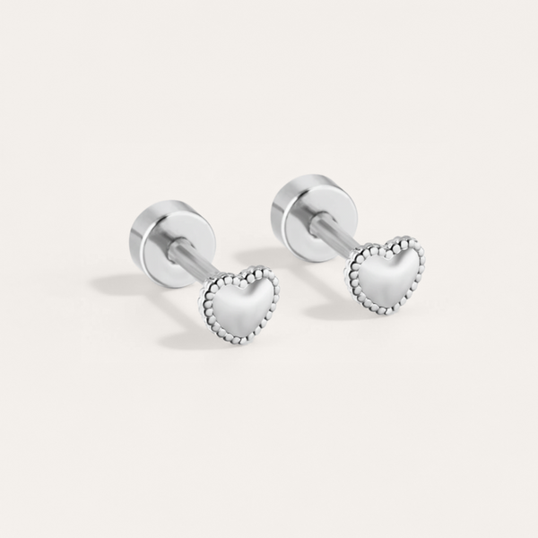 Bead trim heart hypoallergenic flat back stud earring in silver on white background
