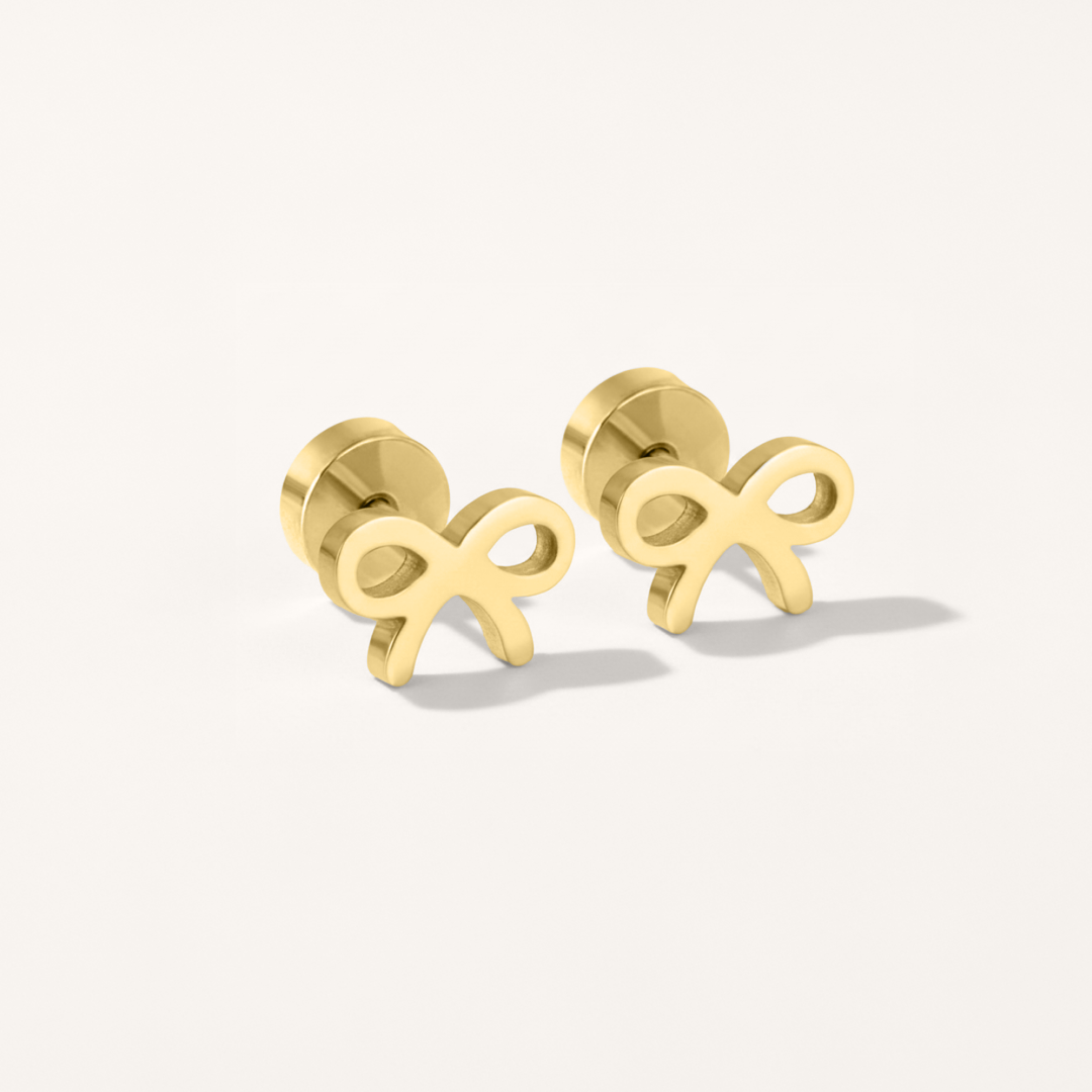 Bow hypoallergenic flat back stud earring in gold on white background.
