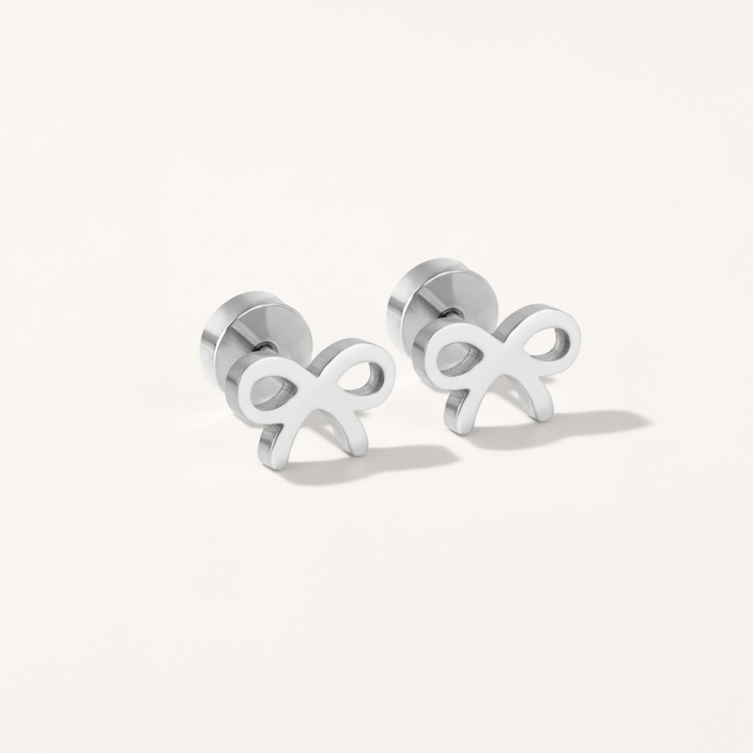 Bow hypoallergenic flat back stud earring in silver on white background