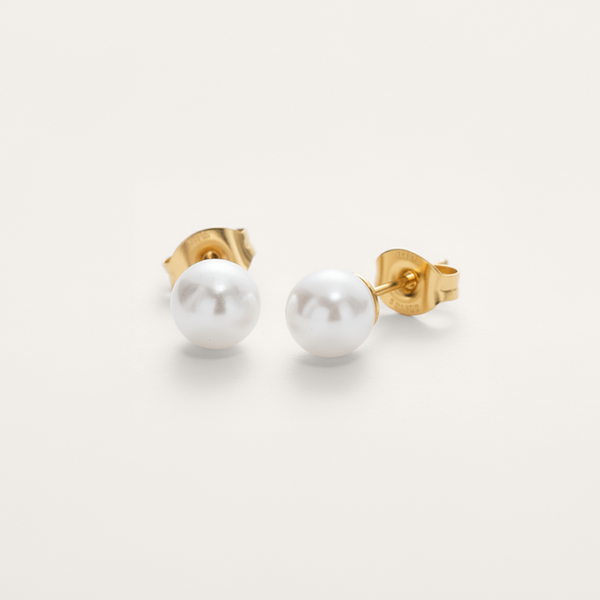 Classic white pearl bead hypoallergenic earrings in gold on white background.