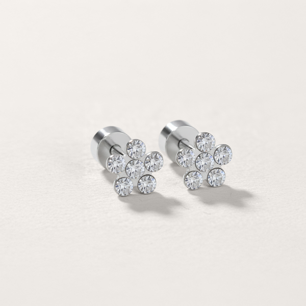 Cubic zirconia flower flat back stud earring in silver on white background