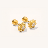 Pair of gold earrings with a clear gemstone on a white background