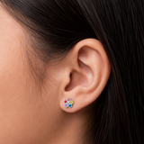A girl wearing a pair of daisy chain flat back earrings.