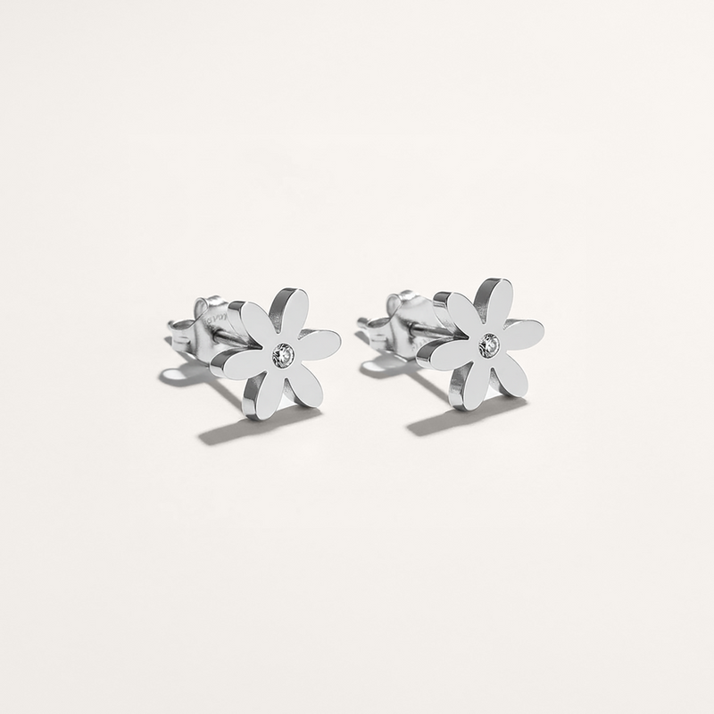Silver flower-shaped earrings on a white background