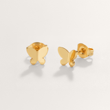 Delicate butterfly hypoallergenic earrings in gold on white background.