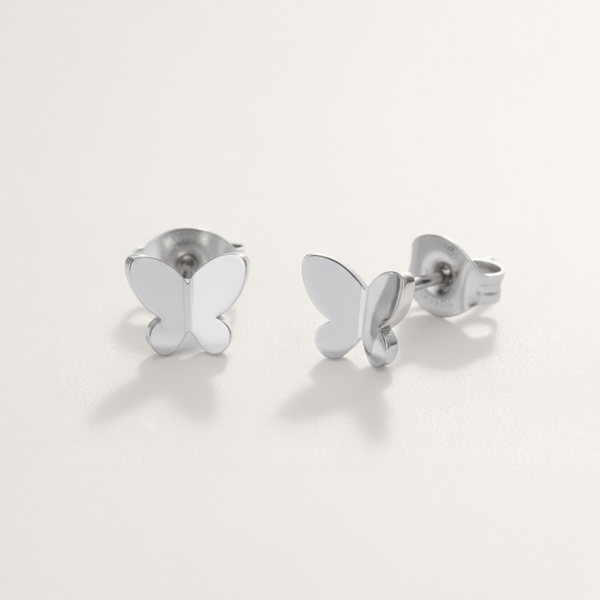 Delicate butterfly hypoallergenic earrings in silver on white background
