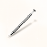 Closeup of an earring grabber on a white background.