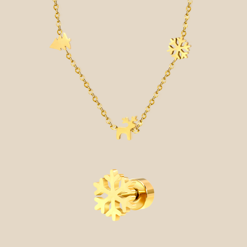 A gold Christmas charm necklace and a snowflake earring on a beige background.