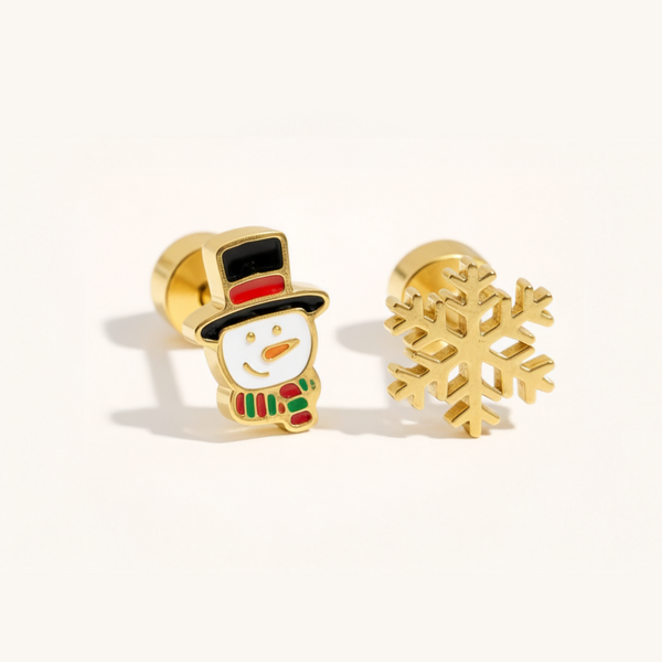 A gold Christmas set with snowflake and snowman earrings on a beige background.