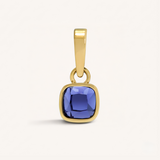 Gold pendant with a purple gemstone on a white background