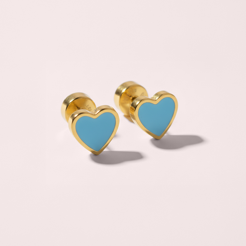 Heart-shaped earrings with gold rims and blue hearts on a light pink background