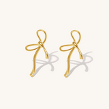 Gold bow-shaped earrings on a white background