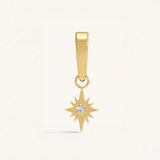 Gold star-shaped pendant with a diamond on a white background