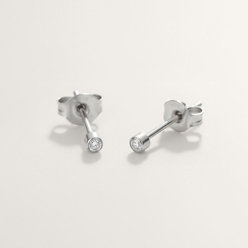 Mini CZ hypoallergenic stud earrings in silver on white background
