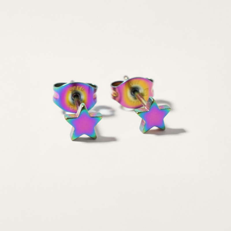 Star-shaped earrings with a rainbow color effect on a light gray background