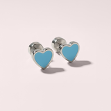 Heart-shaped earrings with blue hearts on a light pink background