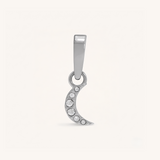 Silver crescent moon pendant with embedded stones on a white background