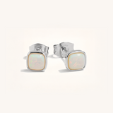 Pair of silver stud earrings with opal stones on a white background