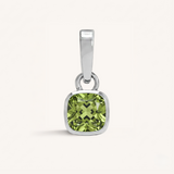 Silver pendant with a green gemstone on a white background