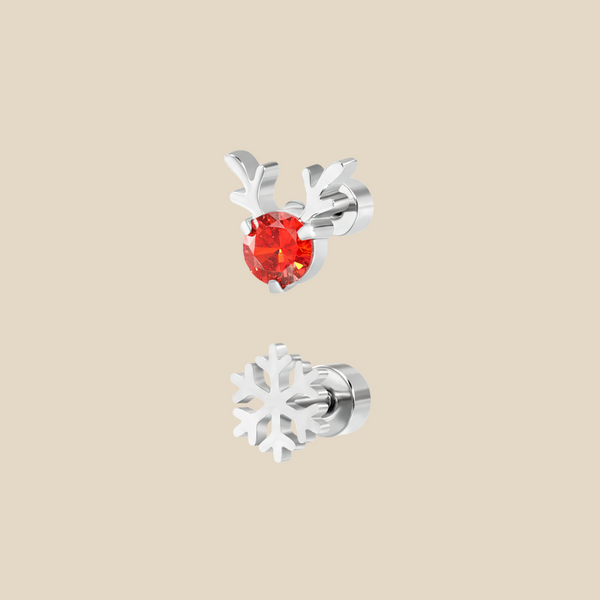A silver Christmas set with a pair of Rudolph sparkle and snowflake flat back earrings on a beige background.