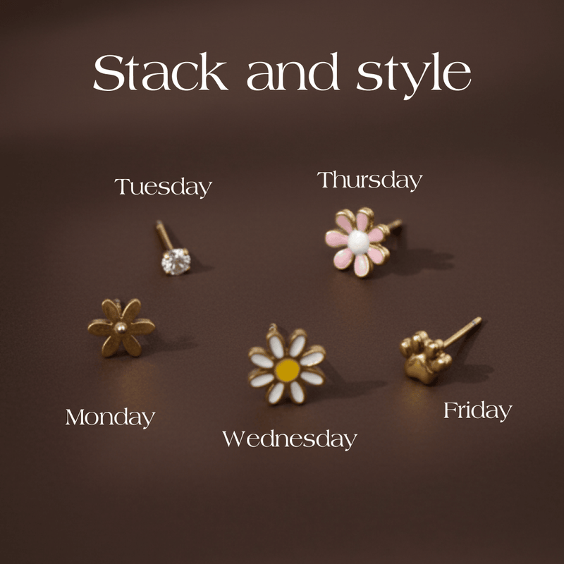 Set of five floral earrings labeled for different days of the week on a brown background.
