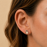 A girl wearing an apple flatback earring.